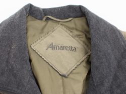 Elegant gray Amaretta™ jacket with olive green lining, blending style and comfort for versatile occasions.