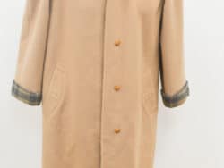 Elegant beige wool coat with plaid details, perfect for stylish layering in any season.