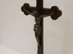 Bronze crucifix on dark wood, a powerful symbol of faith, sacrifice, and spirituality.