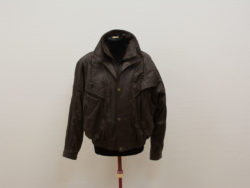 Rugged brown leather jacket with pockets, versatile collar, and relaxed fit for adventurous style.