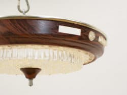 Elegant chandelier with dark wood and crystal accents for luxurious interior decor.