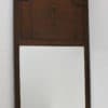 Elegant antique wooden mirror with floral carvings, enhancing vintage charm in any room.