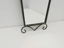 Elegant black metal tabletop mirror with twisted frame, ideal for vintage-inspired home decor.