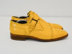 Stylish yellow patent leather double monk strap brogue shoes for bold fashion statements.