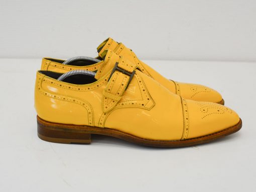 Stylish yellow patent leather double monk strap brogue shoes for bold fashion statements.