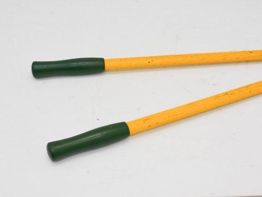 Vibrant yellow trekking poles with green grips for outdoor sports and activities.