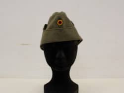 Olive-green military hat with vibrant red and yellow emblem, combining style and tradition.