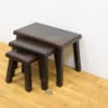 Modern dark wood nested stools: stylish, versatile seating for minimalist living spaces.