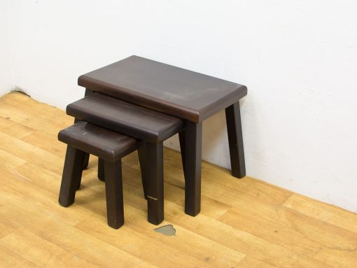 Modern dark wood nested stools: stylish, versatile seating for minimalist living spaces.