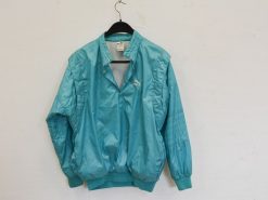 Vintage turquoise Puma windbreaker with quilted design, ideal for retro style and outdoor activities.