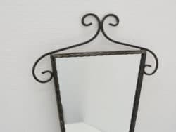 Elegant vintage mirror with a twisted frame, perfect for enhancing any stylish interior space.