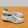 Elegant white T-strap shoes with woven design, ideal for comfort and versatile fashion.