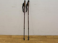 Adjustable burgundy trekking poles with ergonomic grips for comfort and stability during outdoor adventures.