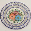 Colorful vintage floral ceramic plate with scalloped edge, perfect for home decor.