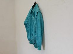 Turquoise bomber jacket for a retro-inspired, casual look with a comfortable oversized fit.