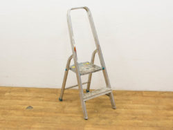 Vintage aluminum ladder with wear, perfect for DIY projects and home improvement tasks.