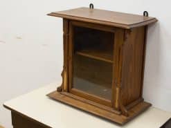 Elegant vintage wooden display cabinet with glass doors, ideal for showcasing treasured collectibles.