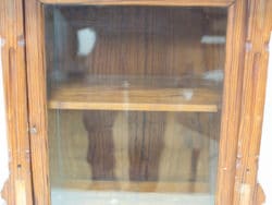 Charming vintage wooden cabinet with glass door, showcasing rustic elegance and character.