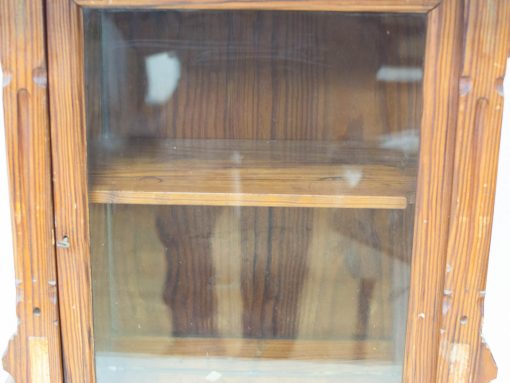 Charming vintage wooden cabinet with glass door, showcasing rustic elegance and character.