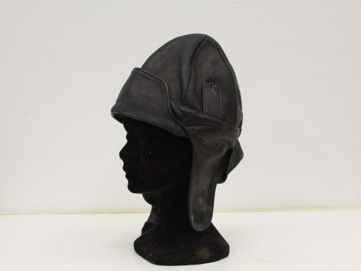 Vintage leather aviator helmet with ear flaps, ideal for collectors and aviation enthusiasts.