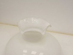 Elegant white porcelain bowl with scalloped rim, ideal for serving or as a decorative accent.