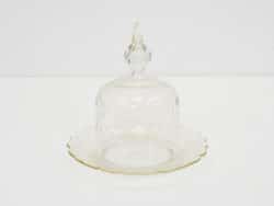 Elegant glass cloche with gold trim, ideal for presenting desserts and enhancing table decor.