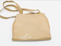 Sleek tan leather handbag with minimalist design, ideal for any occasion and versatile styling.