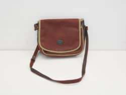 Stylish red crossbody bag with flap closure and adjustable strap, perfect for any occasion.