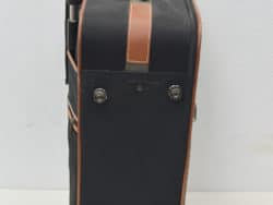 Sleek black suitcase with leather accents, perfect for stylish and practical travel.