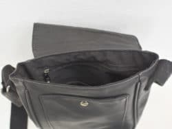 Chic black messenger bag with spacious interior and secure zip pocket for everyday essentials.