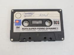 Vintage AGFA Super Ferro cassette tape with handwritten notes, perfect for collectors and music enthusiasts.