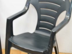 Versatile gray plastic chair with ergonomic design for comfortable indoor and outdoor use.