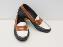 Stylish black and brown loafers with white accents, perfect for any occasion.