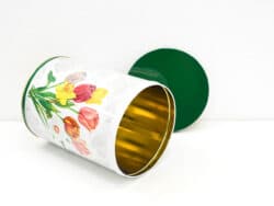 Colorful floral tin canister with gold interior, perfect for stylish storage and decoration.