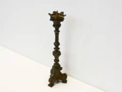 Antique brass candlestick with intricate design, ideal for vintage decor and ambient lighting.