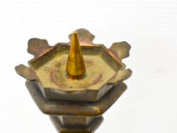 Intricate brass oil lamp with hexagonal base and pointed top, ideal for elegant decor accents.