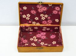 Charming wooden box with floral lining, ideal for jewelry storage and stylish home decor.