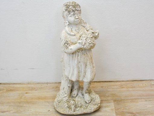 Charming vintage statue of a smiling girl with flowers, perfect for whimsical garden decor.