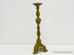 Vintage brass candlestick with intricate floral designs, perfect for stylish home decor accents.