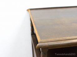 Elegant antique wooden table with rich grain, rounded edges, and timeless charm.