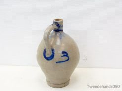 Elegant beige ceramic jug with playful blue design, ideal for rustic decor and practical use.