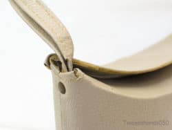 Elegant beige leather handbag with refined stitching and luxurious finish for any occasion.