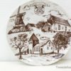 Vintage decorative plate showcasing a windmill and village scene in charming sepia tones.