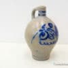 Handcrafted ceramic jug with intricate blue designs, ideal for rustic decor and functional use.