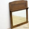 Rustic wooden mirror with shelf, blending vintage elegance and practicality for any space.