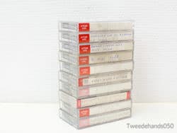 Stack of vintage TDK cassette tapes with handwritten labels, evoking personal music nostalgia.