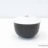 Elegant black and white bowl with lid, perfect for serving and stylish decor.