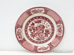 Vibrant red ceramic plate with intricate floral and geometric designs for decorative use.