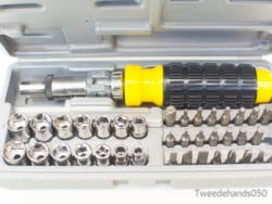 Ergonomic ratcheting screwdriver set with organized bits and sockets in a durable gray case.