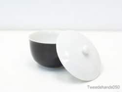 Sleek black and white bowl with lid, perfect for modern serving and stylish storage.